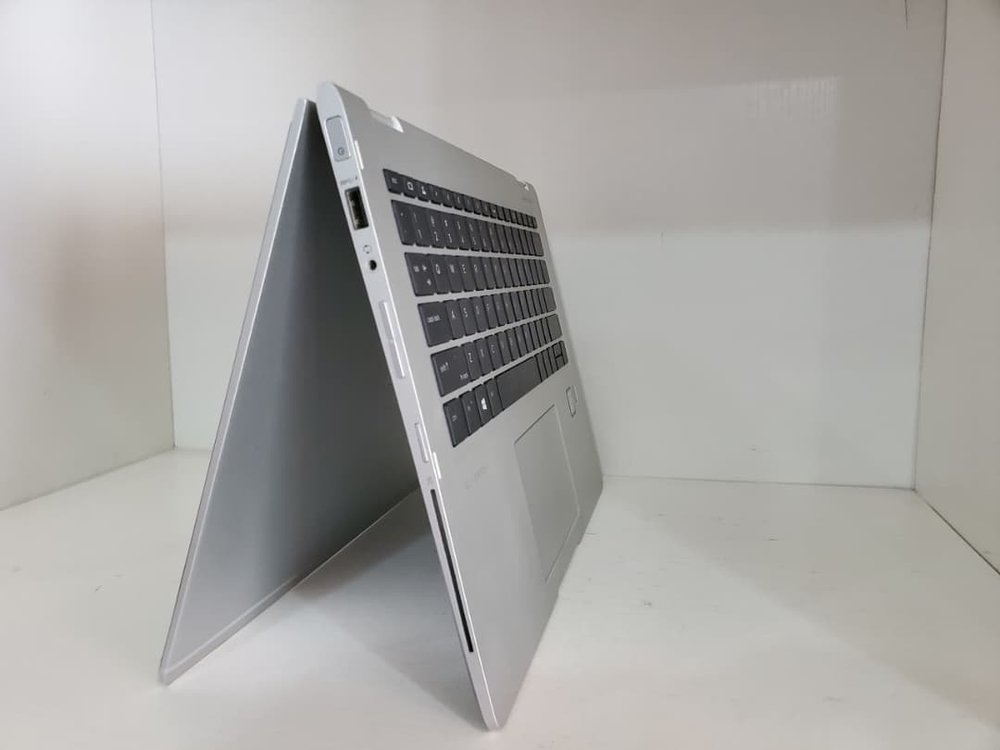 A laptop displayed open at an angle showing its side ports